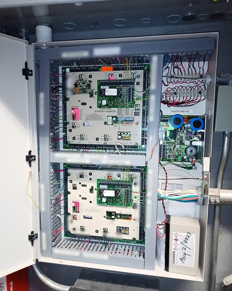 Two door controllers in an enclosure with wire duct, a printed label at every door's wiring.