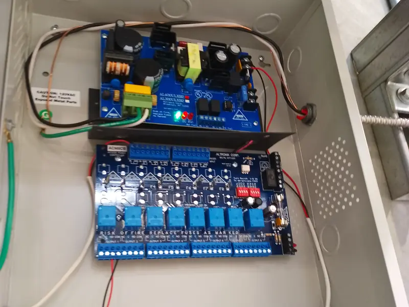 Power supply above a fused distribution board in an enclosure.