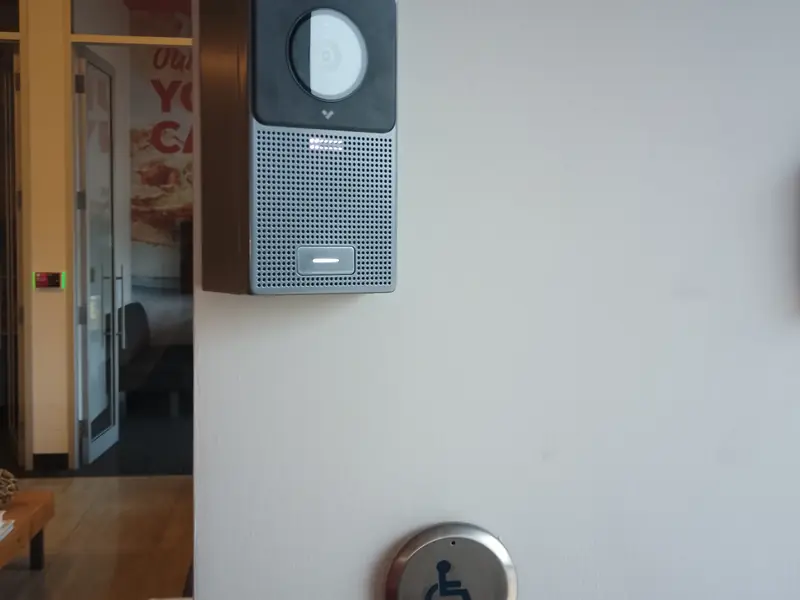 Intercom station, reader and accessible push buttons in a vestibule.